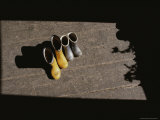 Two Pairs of Boots Sit in Sunlight Coming Through an Open Window Photographic Print