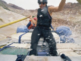 A Female Rafter Takes the Oars in a Raft Traveling Down the Colorado River Photographic Print by Stephen Alvarez