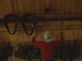 An Outfitter Hangs a Set of Elk Antlers on a Cabin Wall Photographic Print by Raymond Gehman