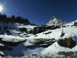 A White-Tailed Ptarmigan Blends into a Landscape of Rock and Snow Photographic Print