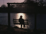 A Woman on a Swing is Silhouetted against Reflected Sunlight Photographic Print by Stephen St. John