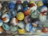 Close View of Colorful Glass Marbles in a Jar Photographic Print by Stephen St. John