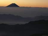 Distant View of Mount Fuji Silhouetted against an Orange Sky Photographic Print by George F. Mobley