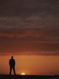 A Man Silhouetted against the Evening Sky in the Yukon Territory Photographic Print by Michael Melford