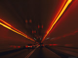 The Taillights of Cars Reflected on the Walls and Ceiling of a Tunnel Photographic Print