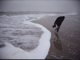 A Lone Figure Braves a Fierce Wind on a Wintry Chincoteague Beach Photographic Print by Medford Taylor