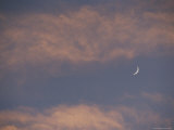 A Crescent Moon on a Partly Cloudy Evening Photographic Print
