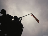 The Iwo Jima Memorial Silhouetted against a Cloudy Sky Photographic Print by Raul Touzon