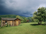 Storm Clouds Form Above a Log Cabin on the Site of French Azilum Photographic Print