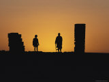 Silhouetted People at Sunset at an Old Desert Telegraph Station Photographic Print by Jason Edwards