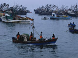 Peruvian Fishermen Head out to Their Anchored Boats off Shore Photographic Print by Maria Stenzel