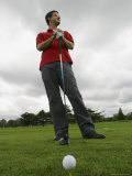 A Man Prepares to Tee off on a Golf Course Photographie