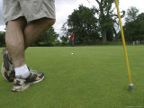 Men Practice Golf on a Putting Green Photographie