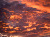 Blazing Cloud-Filled Sky at Sunset Photographic Print by Raul Touzon