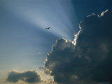 Rays of Sunlight Peek Out from Behind a Cloud Photographic Print