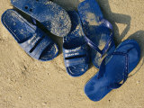 Blue Plastic Sandals, Covered in Sand, Lie on a Beach in Hong Kong Photographic Print by Justin Guariglia