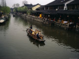Tourists in a Traditional Boat on One of Zhouzhoungs Many Canals Photographic Print by Justin Guariglia