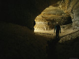 Caver Walks Through a Cave Passage Filled with Gypsum Formations Photographic Print