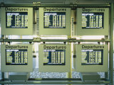 Screens List Airline Departures at an Airport Photographic Print