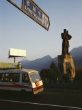 Bus Passes by the Statue of Damo at the Entrance to Shaolin Photographic Print