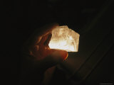 Close View of a Hand Holding an Illuminated Salt Crystal Photographic Print