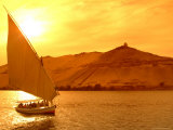 A Felucca Cruises on the Nile River at Sunset Photographic Print by Richard Nowitz