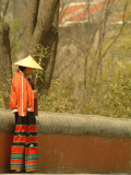 A Chinese Woman in a Straw Hat and Colorful Pants Photographic Print by Richard Nowitz