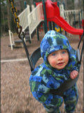 Baby on a Swing at a Playground Photographic Print