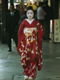 Kimono-Clad Geisha Walks Past Shops Among Other Pedestrians Photographic Print