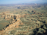 A Small Aircraft Hovers Above Above Canyonlands National Park Photographic Print by Joel Sartore