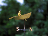 A Weather Vane with a Rowboat and Skipper Figurine Atop It Photographic Print by Darlyne A. Murawski