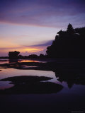 Tanah Lot Temple Silhouetted against a Sky Painted by Sunset Photographic Print by Justin Guariglia