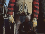 A Cowboy, Wearing a Ripped Jacket, Stands with His Horse and Dog Photographie