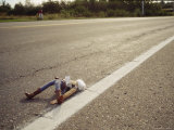 A Discarded Puppet in the Middle of a Road Photographic Print