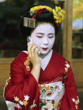 A Kimono-Clad Geisha Talks on a Cell Phone Photographic Print by Justin Guariglia