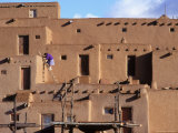 A Woman Climbs a Ladder to an Apartment in an Adobe Complex Photographic Print by Ira Block