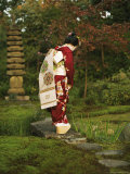 Kimono-Clad Geisha Stands on a Bridge Over a Stream in a Park Photographic Print