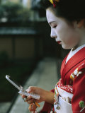 A Kimono-Clad Geisha Dials Her Cell Phone Photographic Print
