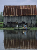 A Family Travels by Rowboat Through Flood Waters after Heavy Rains Photographic Print by Joel Sartore
