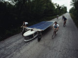 Students of Crowder College in Neosho, Missouri, Ride Beside the Crowder College Star Racer Photographic Print by James A. Sugar