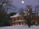 A Full Moon Rises Over a Snow-Covered Mclean Hospital Building Photographic Print by Melissa Farlow