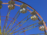 A Ferris Wheel against a Blue Sky Photographic Print by Raul Touzon