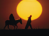 Silhouetted Man Leads a Donkey Bearing a Pregnant Woman, Reminiscent of Joseph and Mary, Israel Photographic Print