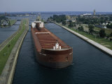 Ore Freighter Ship Exits the Soo Locks on the St. Mary's River, Michigan Photographic Print by Phil Schermeister