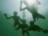 Underwater View of Moken Divers Swimming Underwater Photographic Print by Nicolas Reynard