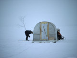 His Fishing Hole Marked by a Branch, an Ice Fisherman Waits for His Next Victim to Take the Bait Photographic Print