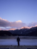 A Woman Watches Alpenglow Touch the Mountaintops at Sunset, Whistler, British Columbia, Canada Photographic Print by Taylor S. Kennedy