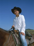 A Cowgirl Sits on a Horse Photographic Print