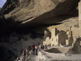 Tourists Admire the Ancient Anasazi Ruins of Mesa Verde, Colorado Photographic Print by Taylor S. Kennedy