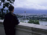A Man Looks Out Over the City from the Castle, Bratislava, Slovakia Photographic Print by Taylor S. Kennedy